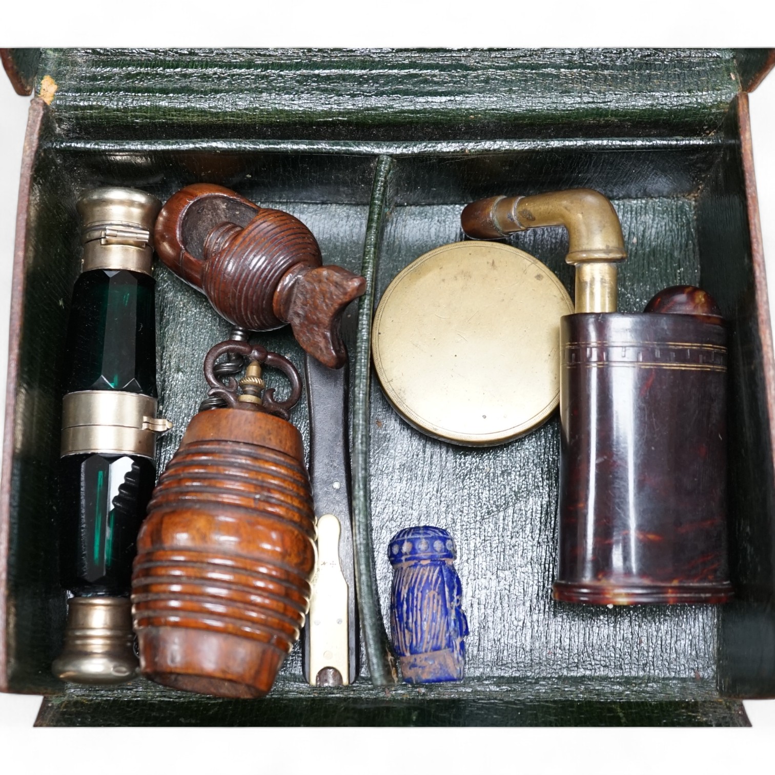 A pocket sundial, a nut cracker, a nutmeg grater, two double ended scent bottles etc., in a leather case, scent bottle 13cm long. Condition - good